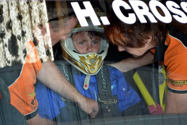 A family day out: Josh Battersby, older brother to Wellington Children's Hospital patient Josh, is secured in to a Suzuki Swift Sport Cup race car at Manfeild recently as part of an afternoon hot-lap treat for some families of their long-term occupants.