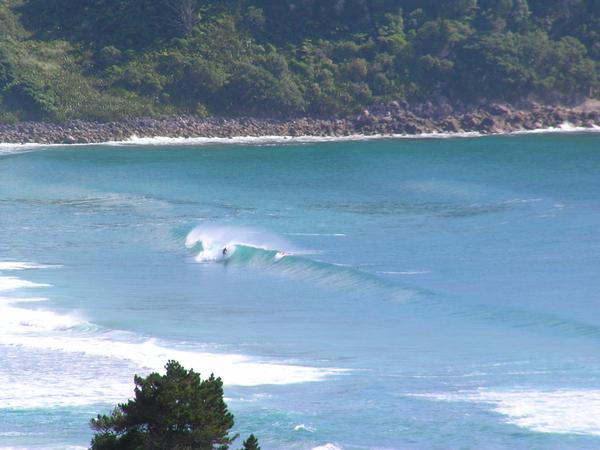 A surfer in the barrel at the North end of Hot Water Beach