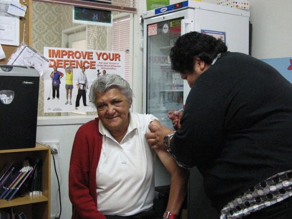 Kuia Margaret Wilson aged 68 (left) gets her annual flu vaccination from nurse Te Rawharangi Mangu of Te Kete Manaaki in Te Kuiti