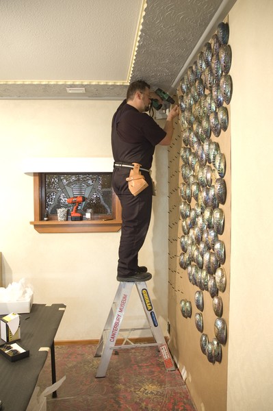 A Canterbury Museum staff member works on the installation of Fred & Myrtle�s Paua Shell House at Canterbury Museum 