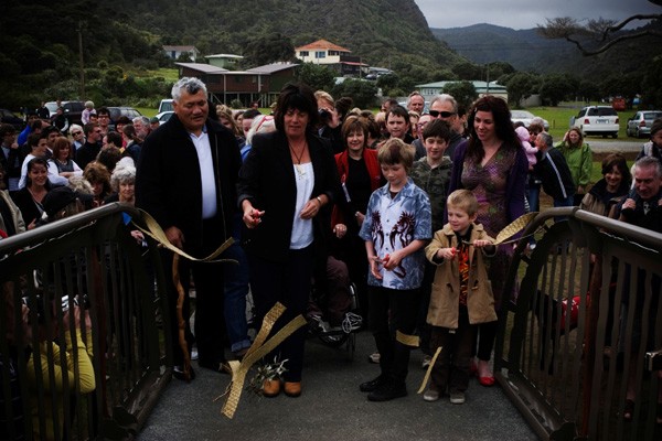 Waitakere Deputy Mayor, Penny Hulse (centre) joins locals to walk across the new �Story of an Eel� footbridge in Piha. Photo Tessa Chrisp.