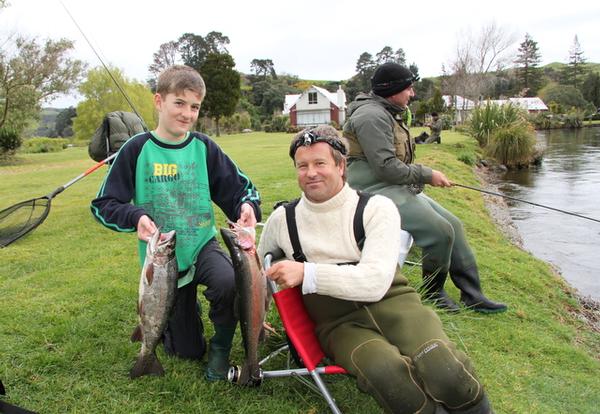 David Bach and 12 year-old son Kevin with the two fish he caught at the Ohau Channel.