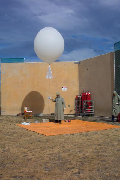 NIWA staff Hamish Chisholm and Alan Thomas preparing (058) and launching (056) a package of sensors to measure temperature, pressure, humidity, ozone, winds and position, using GPS, in the atmosphere up to about 30km, above Lauder in Central Otago.