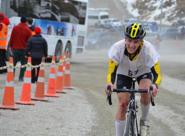 The strain is telling as Braden Currie bikes the last few meters on the Coronet Peak road.