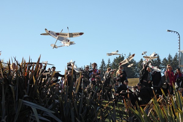 Children of Wanaka launching planes bearing the ancient names of the region as part of Michel Tuffery's Pouwhenua work