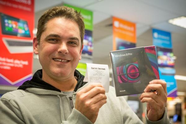 Greg Daniel with the world's first copy of Windows 8 sold in Auckland, New Zealand