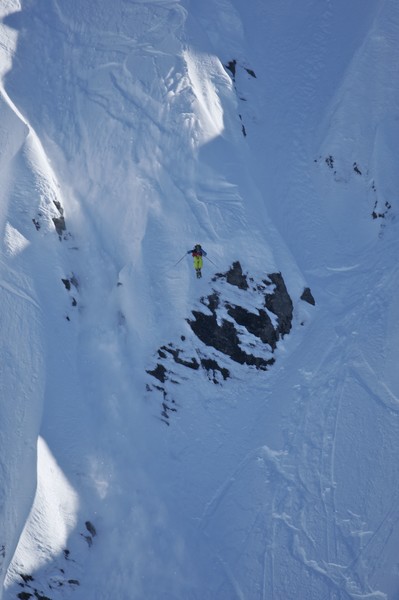 Tim Dutton from U.S. dropping a cliff in the Big Mountain Day of the World Heli Challenge being held near Wanaka in new zealand