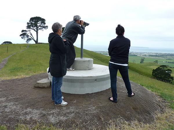 Colin Reeder (Nga Potiki) testing out the new binoculars as Matire Duncan (Nga Potiki) and Courtney Bell (Bay of Plenty Regional Council) enjoy the view.