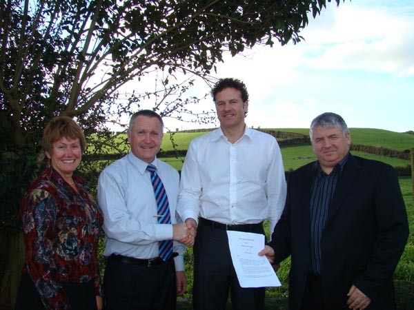 Franklin District Council Chief Executive, Sally Davis and Mayor Mark Ball, with Cape Hill Trust representatives, Layne Kells and Ian Laywood, sign the agreement at the site of the proposed new growth area.