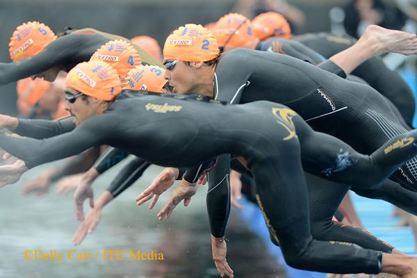 Athletes dive in for the start of the ITU World Triathlon Series race in Yokohama, Japan.