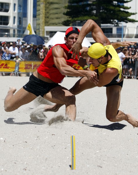 Arch-rivals, Canterbury's Morgan Foster (left) and Ben Willis (Wellington) tangle during the men's beach flags event.