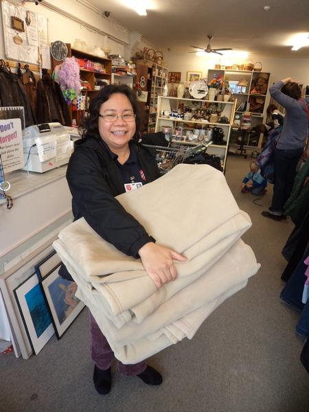 Nenita Naria of the Salvation Army receiving some of the top notch blankets purchased with Caltex customer donations.