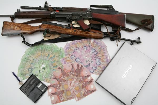 Police recovered , approximately $6000 in cash, three firearms and ammunition