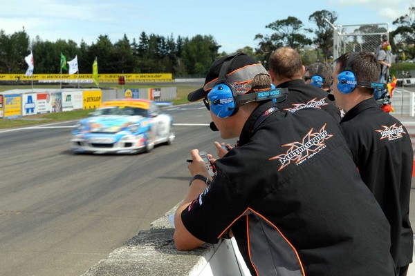 Checking progress of team principal Shane McKillen, Triple X Motorsport personnel log data to help their team to a 146-point lead after today's first race at the penultimate round of the Battery Town Porsche GT3 Cup Challenge being raced at Manfeild.