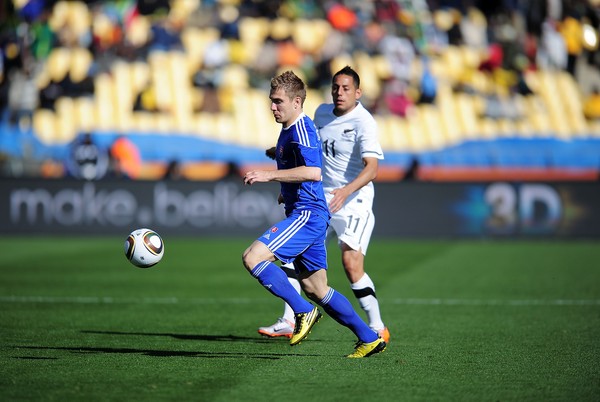 Erik Jendrisek of Slovakia and Leo Bertos of New Zealand compete for the ball during the 2010 FIFA World Cup at the Royal Bafokeng Stadium on June 15, 2010 in Rustenburg, South Africa.