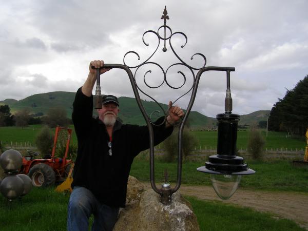 Cr McPhee and the historic gas-light fitting he made.