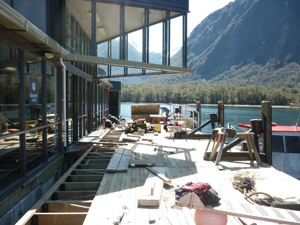  Workmen for Southern Discoveries re-attach the floating pontoon at the Milford Discovery Centre in Milford Sound
