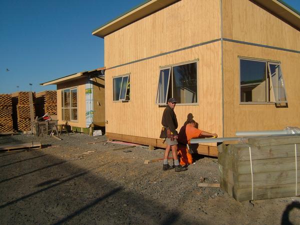 (L to R) Ross MacKay, Habitat for Humanity site supervisor, and a prisoner, build house for local family inside Hawke's Bay Prison