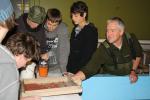 Fish & Game Officer Lloyd Gledhill with Whakatane High Students examining the trout eggs or eye ova.