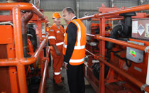 Salvor Drew Shannon (left) shows Transport Minister Steven Joyce (right) the range of pumps, compressors and other gear assembled in Tauranga for the oil recovery and salvage.