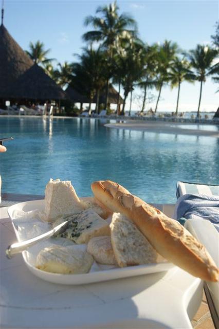 A selection of cheeses and French breads by the pool in New Caledonia