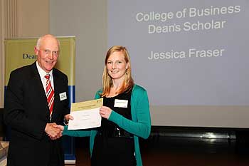Massey University Chancellor Dr Russell Ballard presents  Jessica Fraser with her Dean's Scholar award.