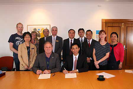 Caption: Professor Chris Moore (seated front row) and Guangzhou Medical University's Vice-President Professor Wei Donghai sign memorandum of understanding. Back row: Professor Harald van Heerde (Massey), Jean Lim (Massey), Dr Sandy Bulmer (Massey), Dr Lu Jiachun (GMU), Associate Professor Russell Gregory-Allen (Massey), Mr Chang Qing (GMU Vice-President), Professor Liu Jun Rong (GMU), Deputy Director General Hu Bingjie (GMU), Sandra Mohl-de-Vallejo (Massey), Professor Zhou Ying (GMU).