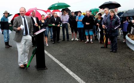 Wet conditions did not deter about 80 people from attending the opening of the new Kopane Bridge by Rangitikei MP Ian McKelvie on Saturday.