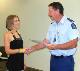 Alice Yuretich, with Inspector Paul Dimery,  NZ Police, who was presenting her with a certificate.