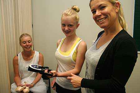 Wendy Jessup looks on as her daughter Eden tests her muscle strength, under the supervision  of Massey Nutrition researcher Sarah Mitchell.