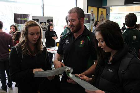 Sports management practicum student Andrew Hill (centre), who is  working at Manawatu Rugby talks with students Jennifer Grubb and  Chelsea Atkin.