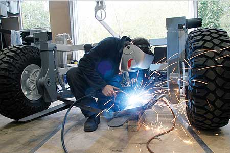 Alistair Scarfe uses an arc welder on the forks that carry the picker�s bin