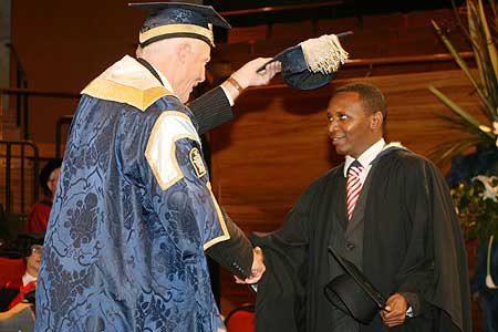Mona Andreas has his degree conferred by Chancellor Russ Ballard.