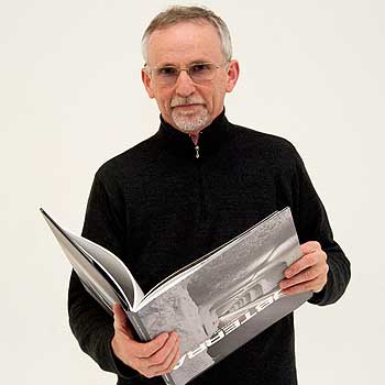 Associate Professor Wayne Barrar with a copy of his  award-winning book An Expanding Subterra.