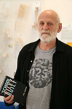 exhibition project coordinator Luit Bieringa, who is  holding a copy of a book about Arthur Riley the  founder of the Wellington School of Design.