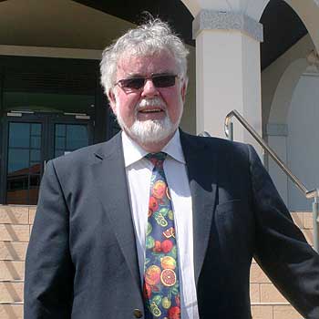 Professor Emeritus Errol Hewett makes a sartorial statement with his  fruit-motif ties, which he wears to promote the horticulture industry.