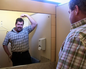 MAKINO Aquatic Centre Manager, Iain Brown checks out the locks that will soon be lost in the Child Cancer shave-off. 