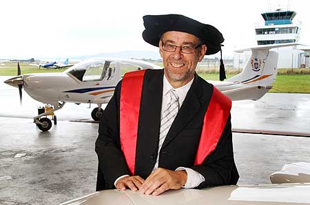 Dr David Lyon at Massey University's Milson flight training centre, just prior to his graduation ceremony. He is only the third person to graduate with a PhD from Massey University's School of Aviation.
