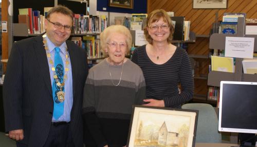  Mayor Ray Wallace with local identity Vera Ellen and sister-in-law Kate Ellen at the Petone Library with the Percy Mill painting.