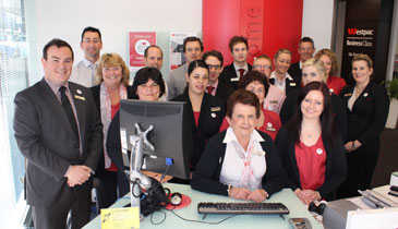 Staff at Westpac's High Street, Lower Hutt, branch wearing 'I Love Hutt City' badges. 