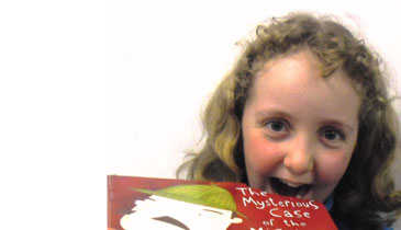 Amy Broeders, 10, of Hutt Central, takes an imaginary bite into one of the many books about all things scrumptious that feature in the holiday reading programme.