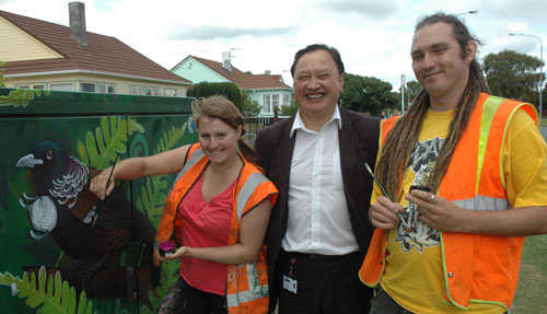 Hutt City Council graffiti eradication officer Delly Ranginui with artists Emily Roberts and Kane Smith with an almost complete artwork in Taita.