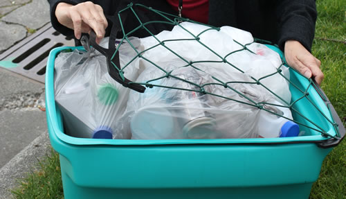Flexible net designed to prevent the contents of recycling bins blowing away in the wind. 