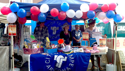  Team effort: Students take a breather from sausage sizzles to run a stall at a street fair in the city.