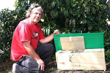 Idan Shapira with a lure rat cage used to attract  and trap wild rats in conservation areas.