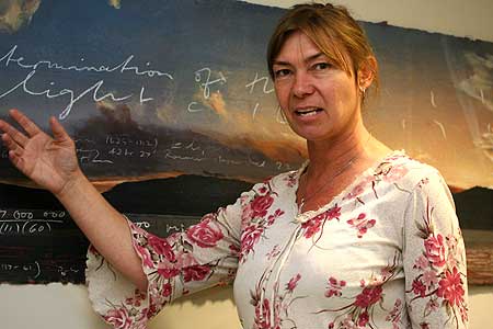 Mathematics teacher Kerri Spooner decodes a mathematical formula on a painting by mathematician-artist Peter James Smith, at Massey's Institute of Information and Mathematical Sciences where she has been a Royal Society of New Zealand Teachers' Fellow.