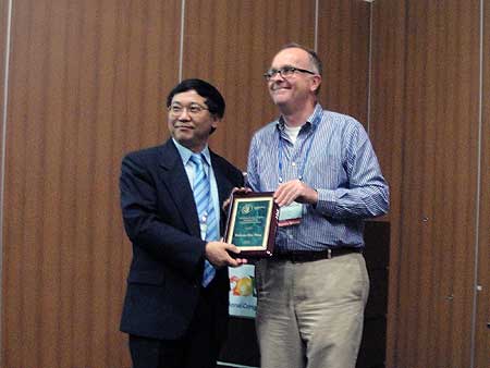 Professor Qiao Wang was presented the award by the international branch president  Professor Christian Borgemeister.