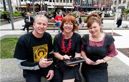 Citylink's Brian Phillips, the Mayor, and Kiwibank's Nicky Ashton test the Wi-Fi in Midland Park 